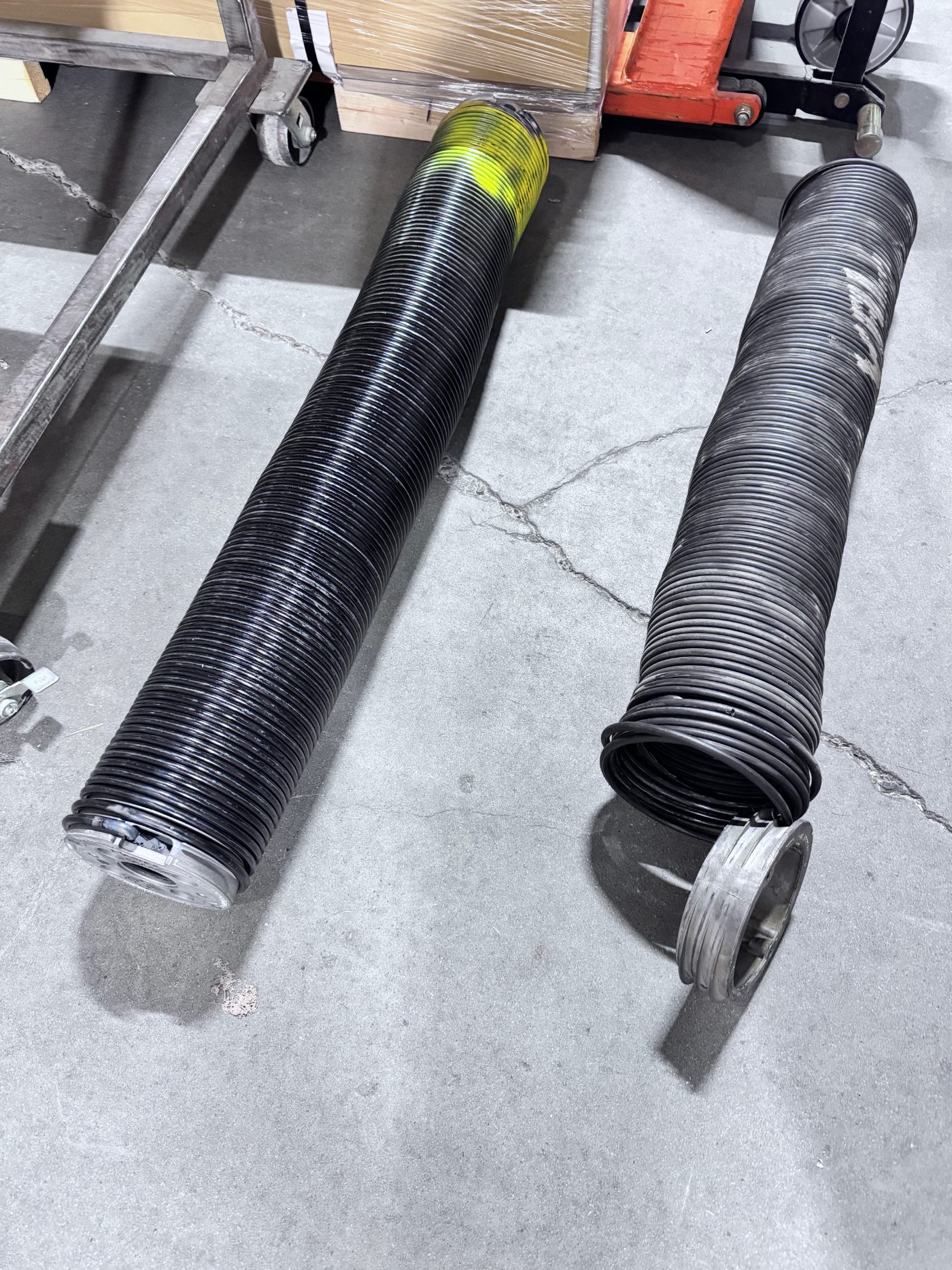 Two new heavy-duty commercial torsion springs ready for installation by POCO Garage Doors in Coquitlam