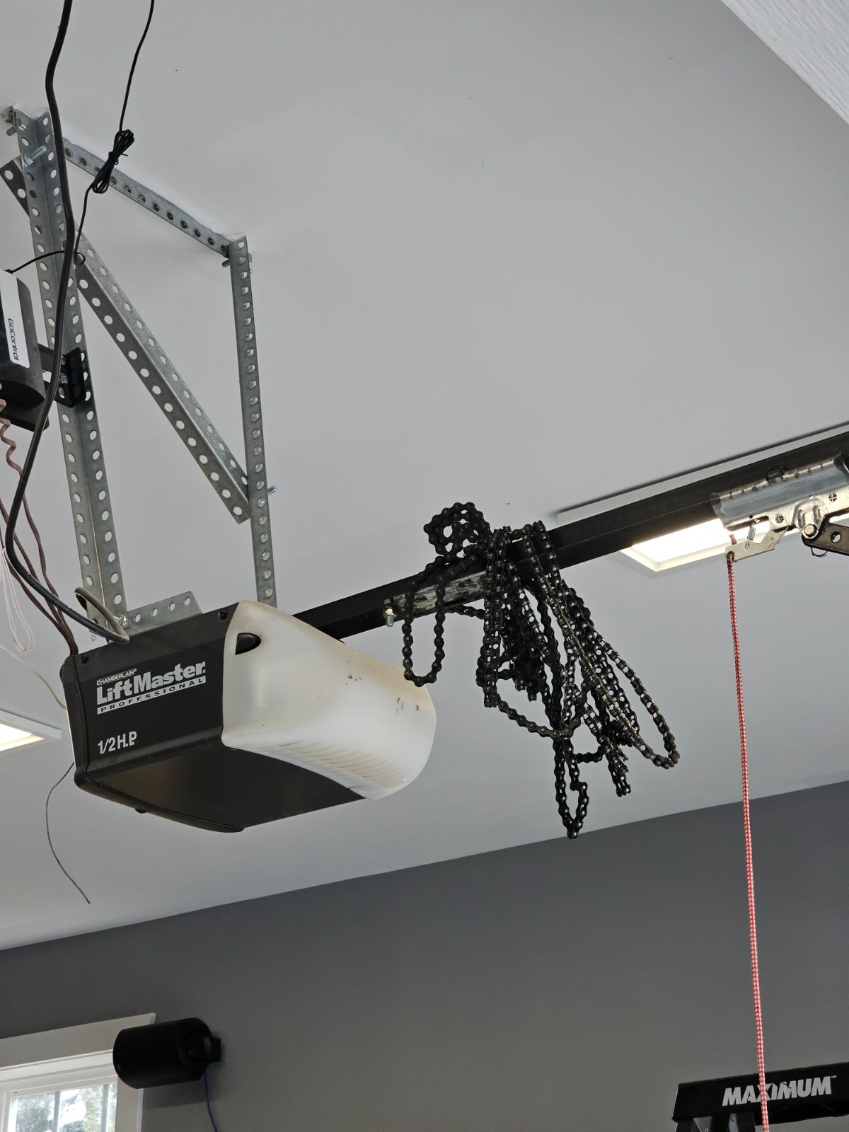Old Chamberlain LiftMaster Professional 1/2 HP opener in a Port Coquitlam garage with a derailed chain hanging loose off the rail