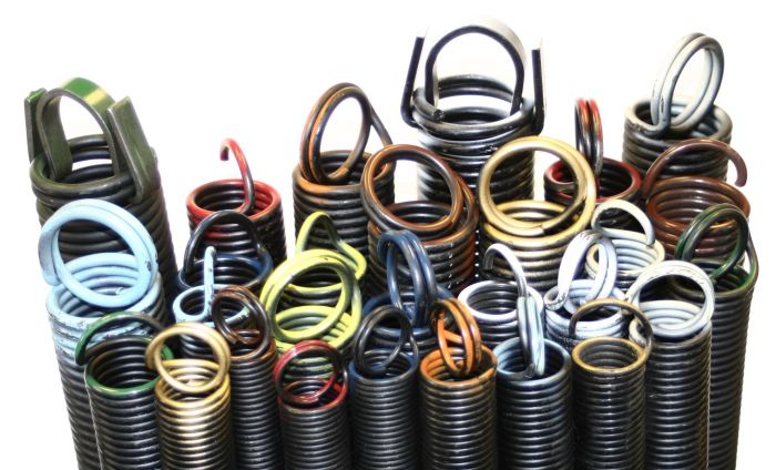 Assortment of colour-coded garage door extension springs in every standard size stocked on POCO Garage Doors service trucks